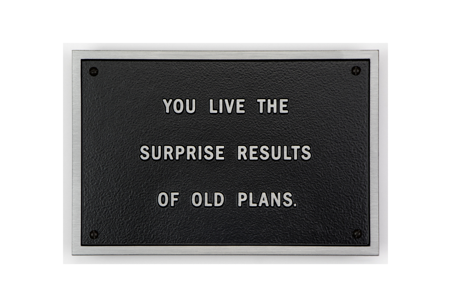 Jenny Holzer plaque that says: You live the surprise results of old plans Jenny Holzer plaque that says: You live the surprise results of old plans